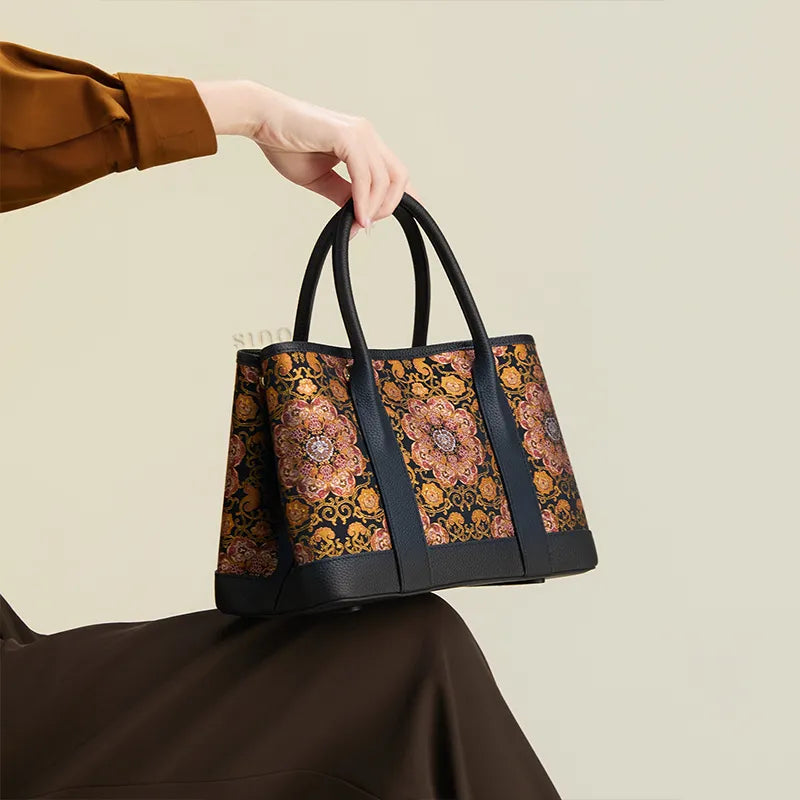 Seated model displaying the Luxury Chinoiserie Dayun Brocade Pomegranate Motif Silk Handbag on the knees.