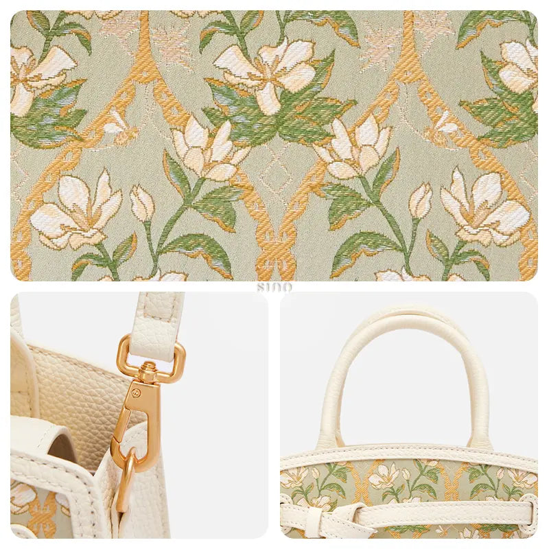 Detail view of the verdant floral Dayun brocade, gold-tone hardware, and ivory leather handles on this luxury top handle bag.