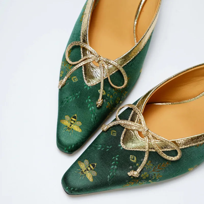 Luxury emerald silk brocade kitten heel mules with pointed toe and open back silhouette.