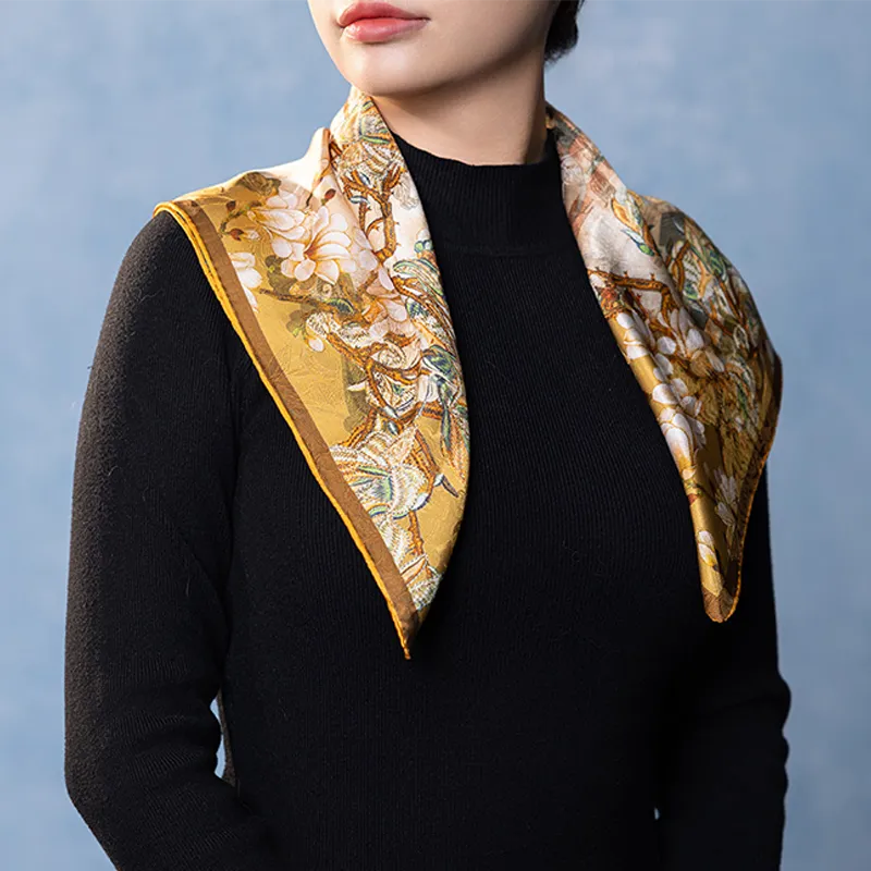 Front view of a Luxury Nanjing Brocade Bloom silk square scarf draped over a black top with floral palace-inspired print.