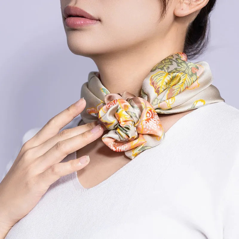 Luxury Nanjing Brocade Cherry Blossom Birds mulberry silk square scarf styled around the neck with a floral knot.