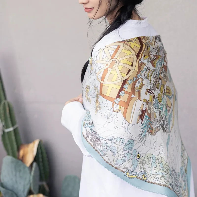 Model wearing the Luxury Nanjing Brocade Six Dynasties Elegance mulberry silk large square scarf draped over the shoulders, showing the pale blue border and elegant scenic print.