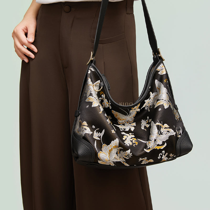 Front model view of the Luxury Shu Brocade Osmanthus Butterfly Leather Crossbody Bag, highlighting the osmanthus and butterfly pattern and adjustable shoulder strap.