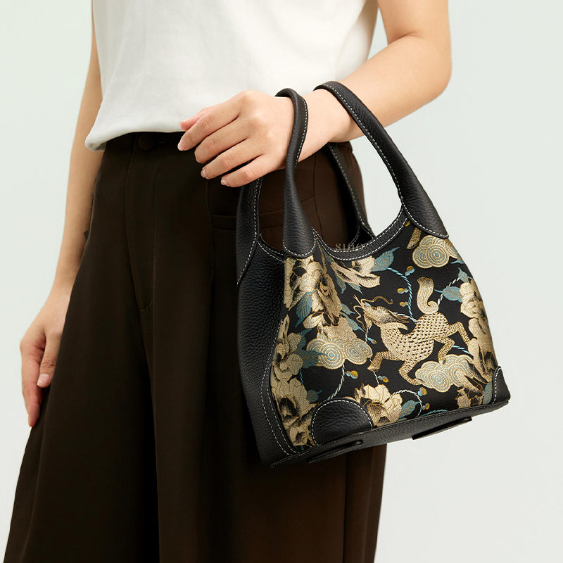 Model carrying luxury Song Brocade Qilin peony leather basket tote bag, side front view highlighting elegant daily wear styling.