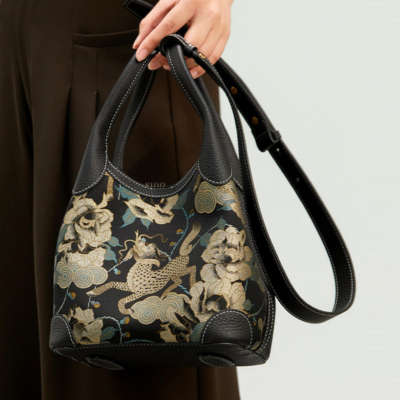 Side view of model wearing luxury basket tote bag with adjustable strap, showing Qilin peony Song Brocade texture and structure.