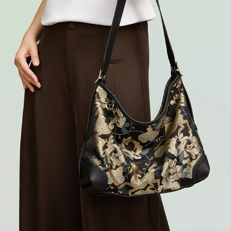 Full model view of the Luxury Song Brocade Black Gold Qilin Peony Leather Crossbody Bag, showing the elegant drape, black leather body, and black gold brocade design.