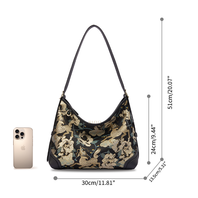 Size reference image of the Luxury Song Brocade Black Gold Qilin Peony Leather Crossbody Bag, shown with a phone for scale.