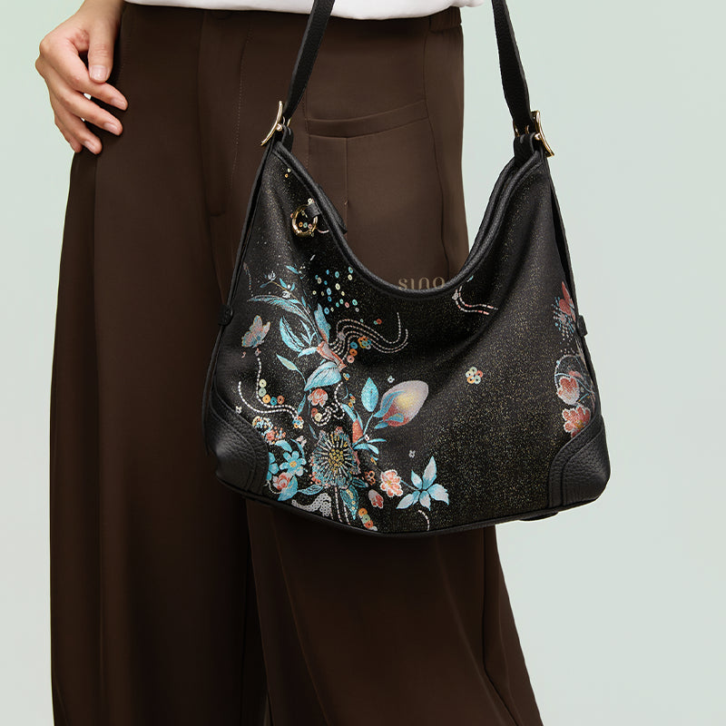 Front model view of the Luxury Song Brocade Blooming Flowers Leather Crossbody Bag, highlighting the colorful blooming flowers motif and adjustable shoulder strap.
