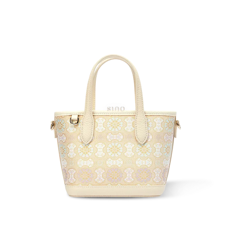 Front view of luxury Song brocade ivory Dingsheng motif top-handle tote bag on white background.
