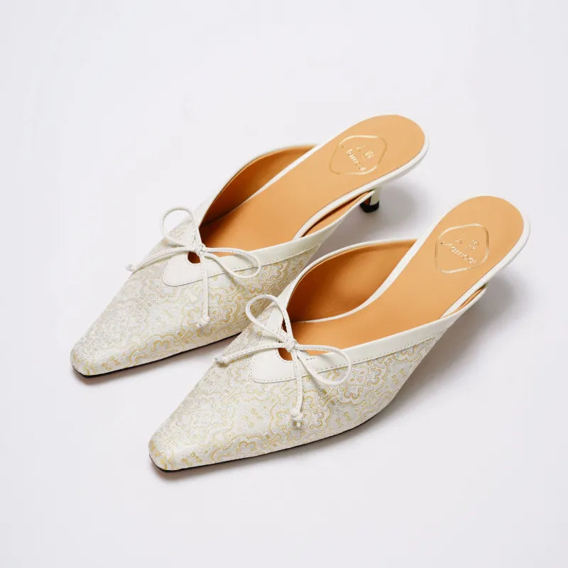 Luxury Song Brocade mules with pointed toe and bow detail, combining traditional Chinese style with modern elegance.