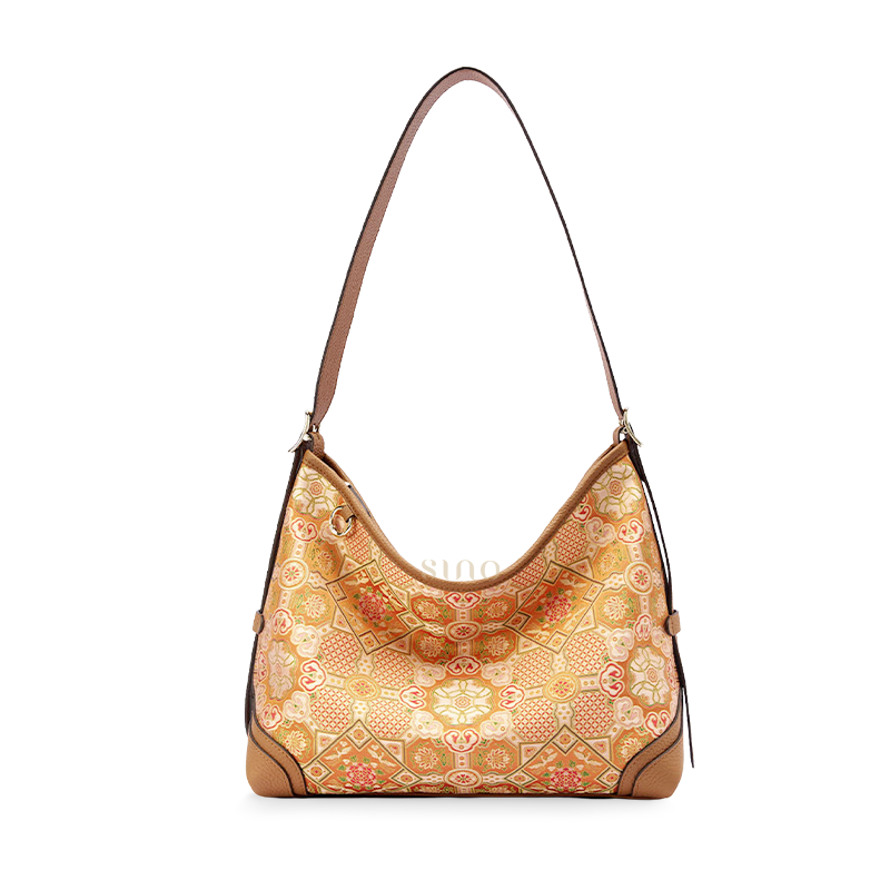 Front view of the Luxury Song Brocade Orange Peony Motif Leather Crossbody Bag, featuring an orange floral brocade pattern with brown leather trim.