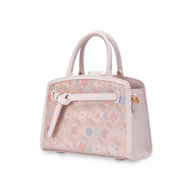 Angled view of the Luxury Song Brocade Ruyi Longevity Motif Leather Top Handle Bag showing its structured silhouette and refined song brocade design.