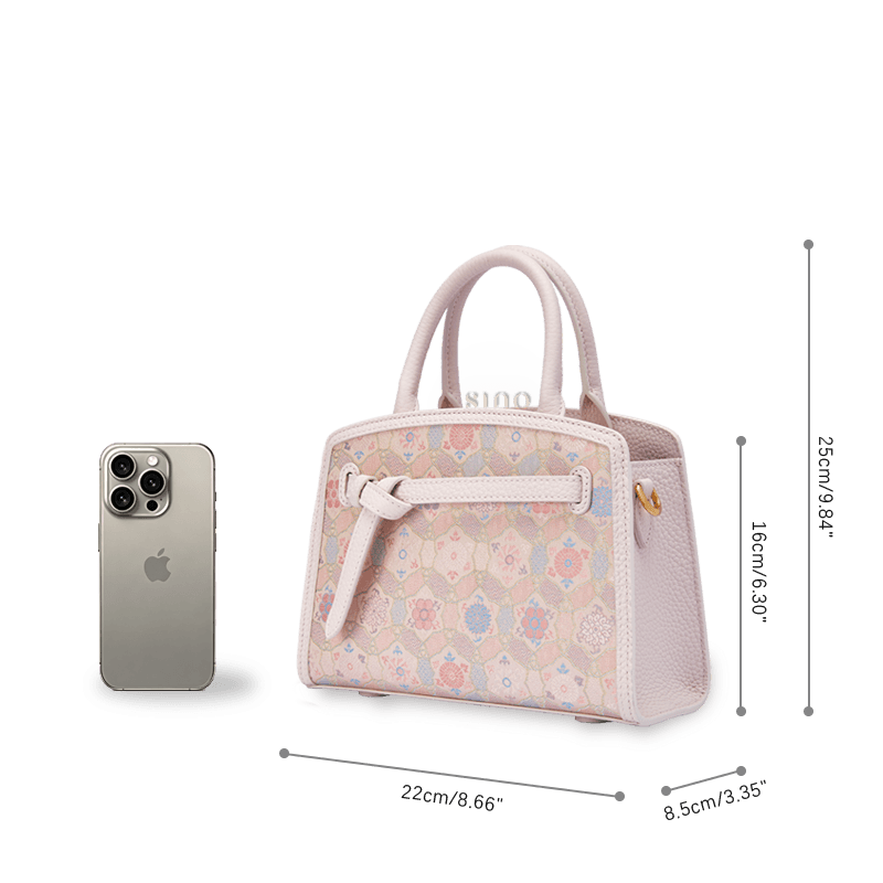 Size reference image of the Luxury Song Brocade Ruyi Longevity Motif Leather Top Handle Bag beside a smartphone.