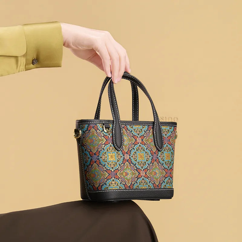Seated model displaying the Luxury Song Brocade Scrolling Foliage & Lotus Motif Handbag on the knees.