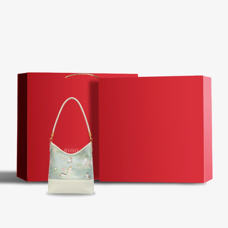 Luxury Springtime Tales Song Brocade shoulder bag displayed with an elegant red gift box.
