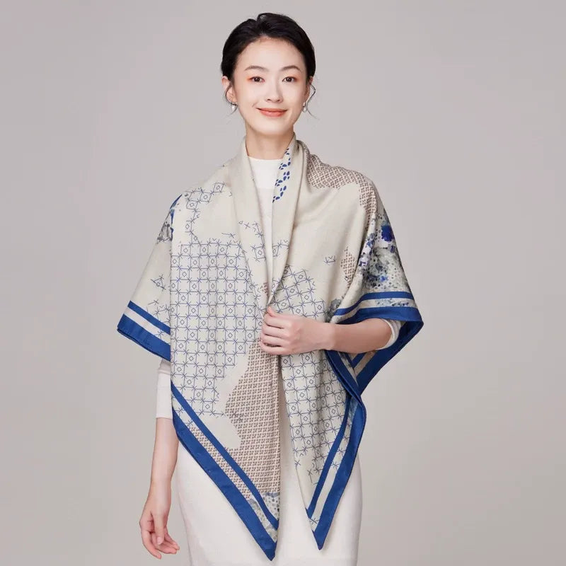 Model holding both ends of wool & silk square scarf.