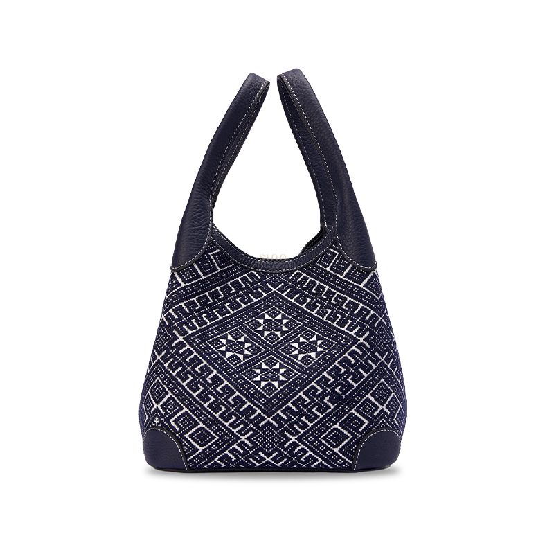 Chinoiserie luxury Zhuang brocade Flying Swallow leather basket tote bag front view on white background, showcasing intricate woven geometric brocade pattern and structured basket silhouette.