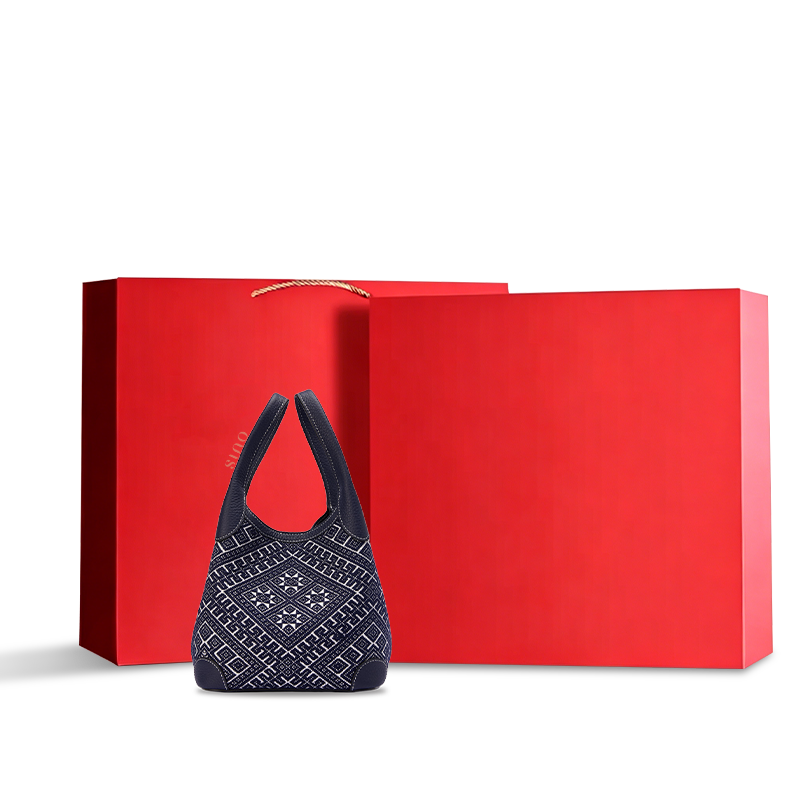 Luxury red gift box packaging of Chinoiserie Zhuang brocade flying swallow leather basket tote bag, presented in premium packaging suitable for luxury gifting and high-end retail display.