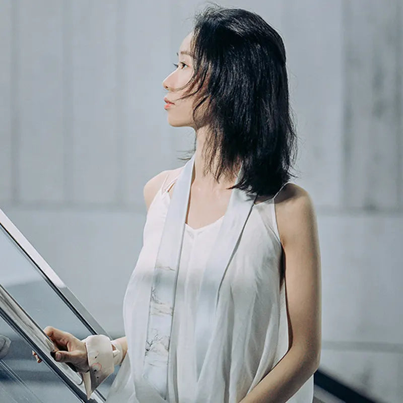 Woman wearing the Chinese Misty Landscape Mulberry Silk Twilly as an elegant long neck scarf.