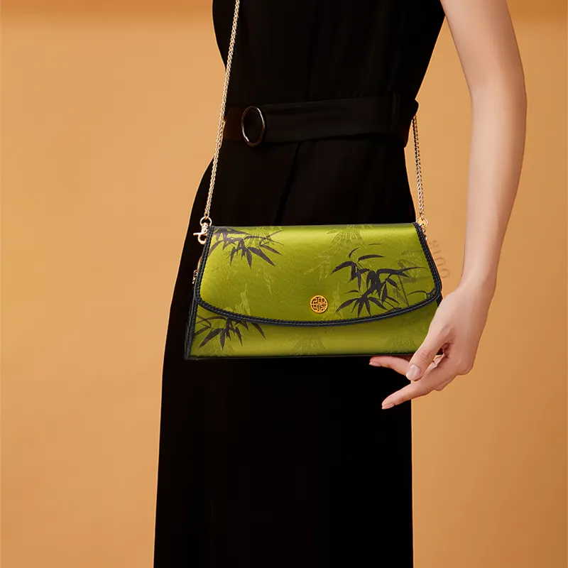 Model in Black Qipao Crossbodying Chinoiserie Vintage Bamboo Silk Clutch.