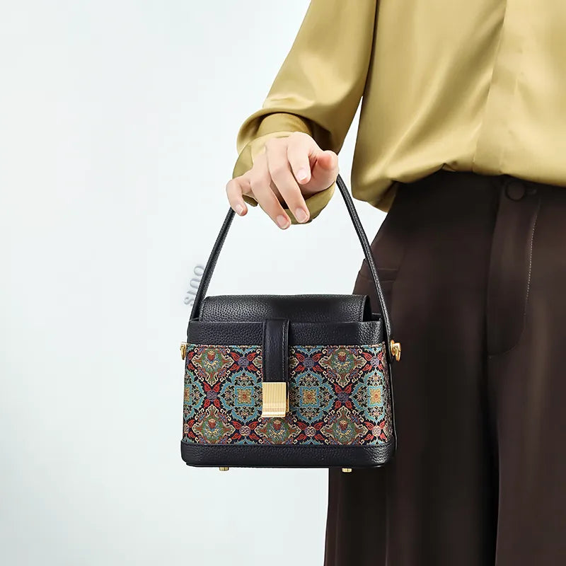 Model holding Song brocade bag at front position.