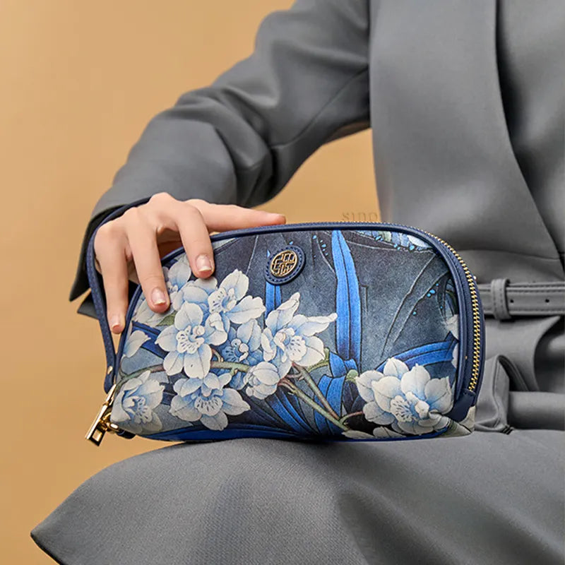 Model Sitting with Blue Orchid Clutch on Lap.