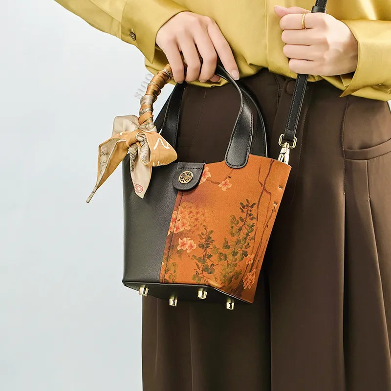 Model carrying embroidered handbag crossbody style.