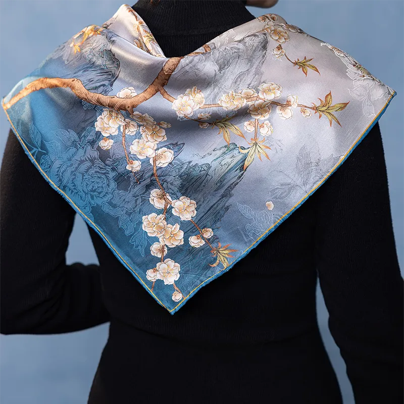Back view of the blue side of a Luxury Nanjing Brocade Bloom mulberry silk square scarf draped over the shoulders.