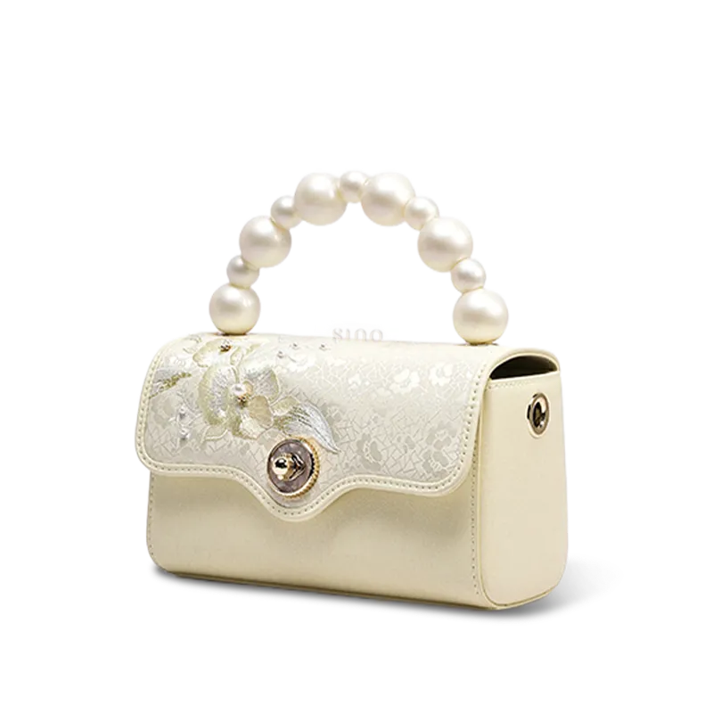 Side profile of luxury silk handbag showing depth.