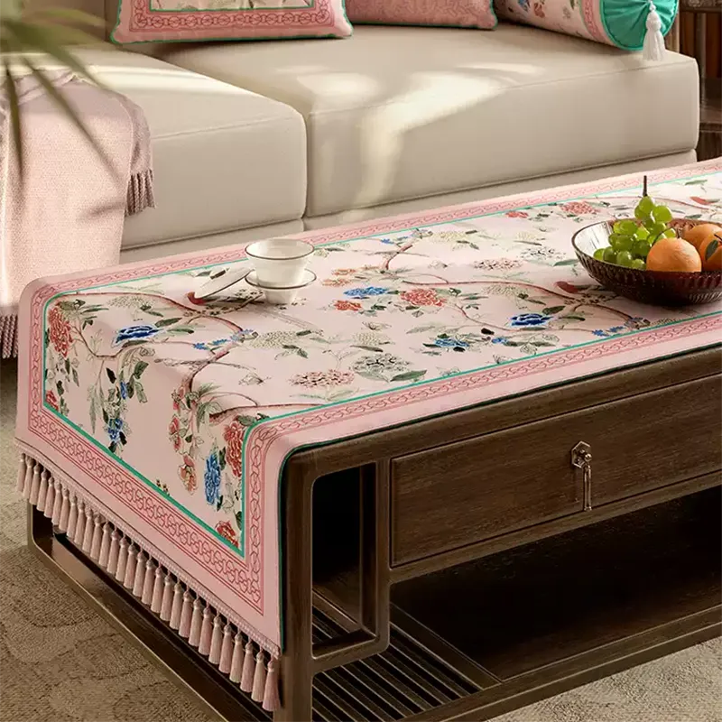 Close-up of Chinoiserie floral pattern on pink tablecloth.