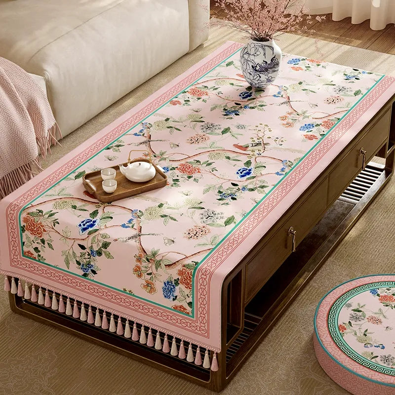 Decorative fringe trim on pastel pink tablecloth.