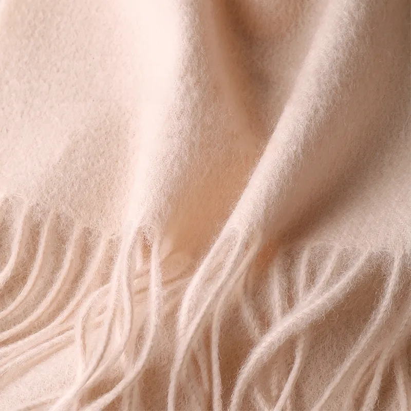 Delicate hand-knotted fringe on embroidered cashmere scarf.