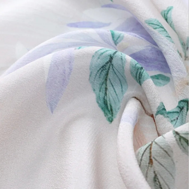 Close-up of premium mulberry silk fabric on the Chinese Poetic Blossom Long Scarf showing its soft texture and delicate floral print.