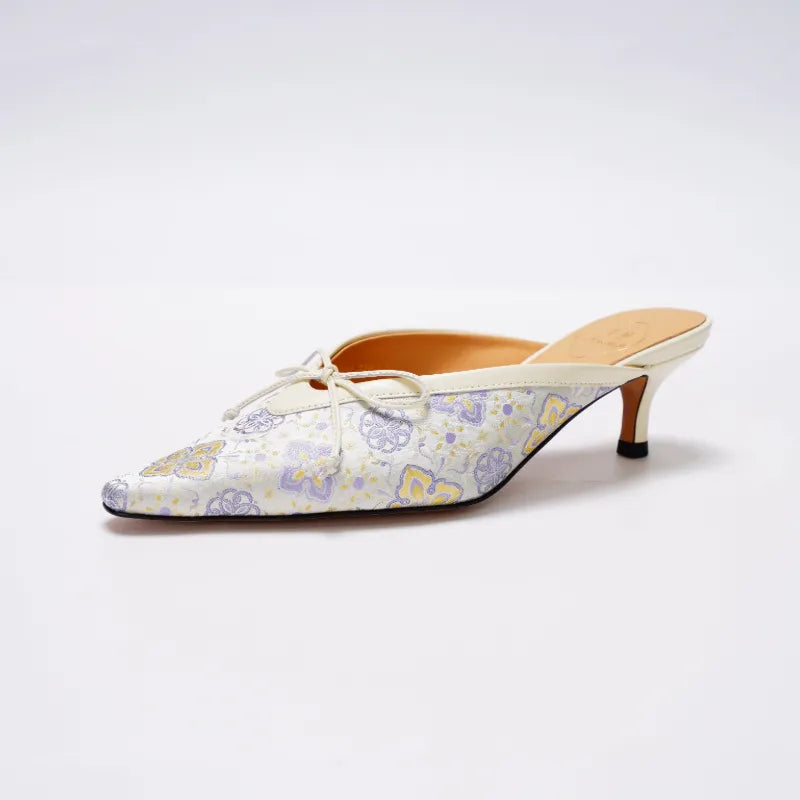 Pointed toe Shu Brocade kitten heel mules with elegant low heel and open-back design.