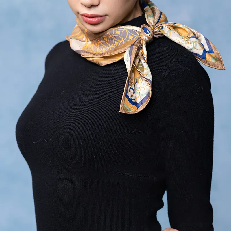 Luxury Nanjing Brocade Pomegranate Grape Motif silk square scarf tied in a side neck knot with brown and blue details.