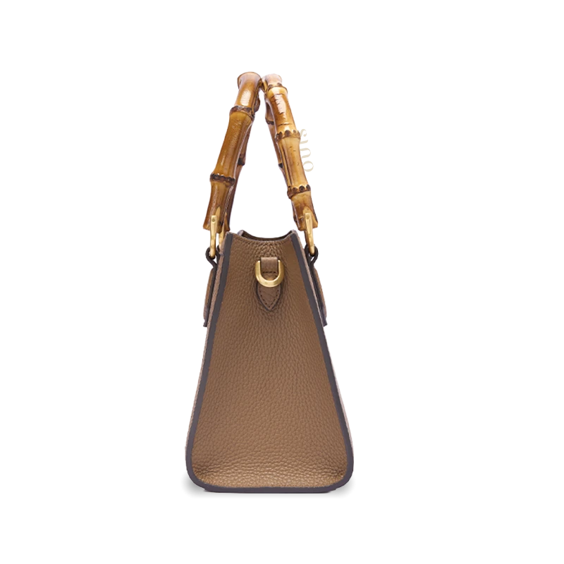 Side view of Shu Brocade Qilin motif bamboo handle handbag showing structured leather silhouette and natural bamboo handle design.