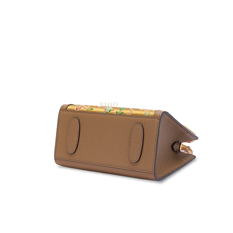 Bottom detail of Shu Brocade Qilin bamboo handle handbag highlighting durable full-grain leather construction and structured base.