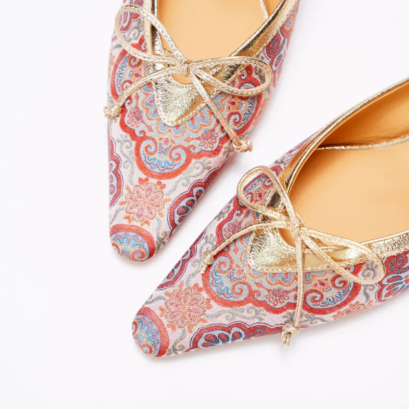 Close-up of Song Brocade mules showing intricate Auspicious Bloom floral motif and woven texture.