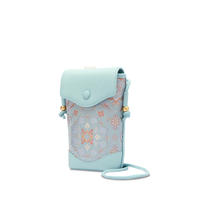 Front view of a light blue Song brocade Baoxiang floral crossbody phone bag with textured leather trim and gold-tone accents.