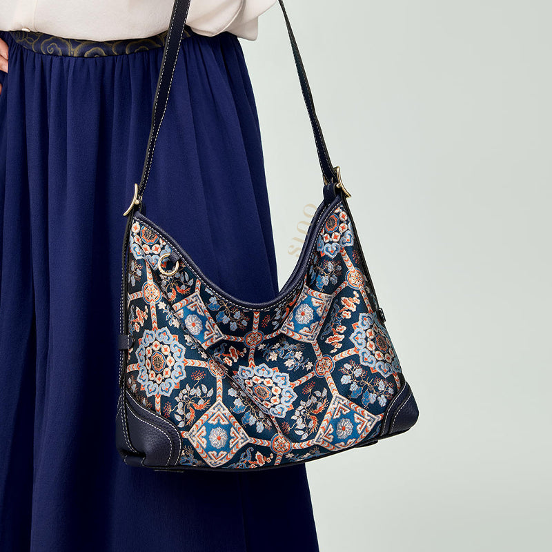 Model carrying the Luxury Song Brocade Blue Baoxiang Floral Leather Crossbody Bag, front view highlighting Baoxiang floral design.
