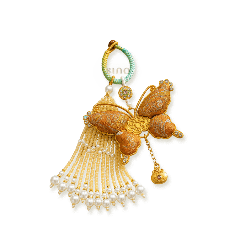 Gold Song Brocade butterfly pearl tassel bag charm isolated on a transparent background with layered pearl tassels and gold-tone accents.