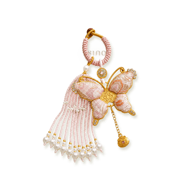 Pink Song Brocade butterfly pearl tassel bag charm isolated on a transparent background with pearl tassels, gold-tone accents, and a woven butterfly motif.