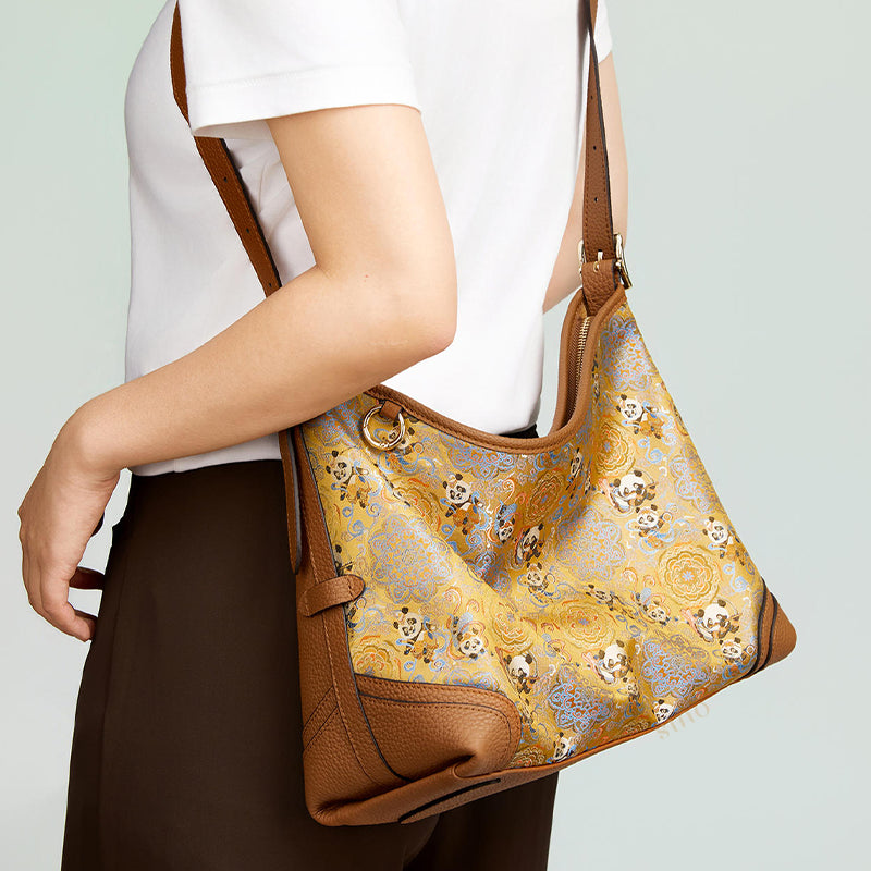 Side model view of the Song Brocade Chang’an Court Dance Leather Crossbody Bag, showing the shoulder fit, brown leather trim, and brocade pattern.