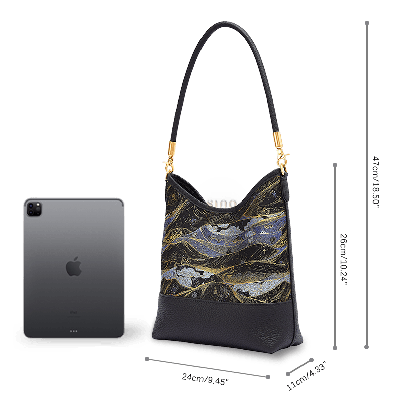ize and capacity comparison of the Moonlit Splendor leather shoulder bag beside a tablet.