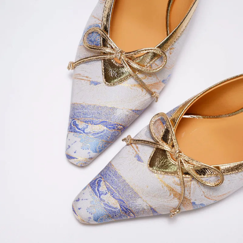 Close-up detail of Song Brocade mules featuring elegant bow accent and traditional textile craftsmanship.