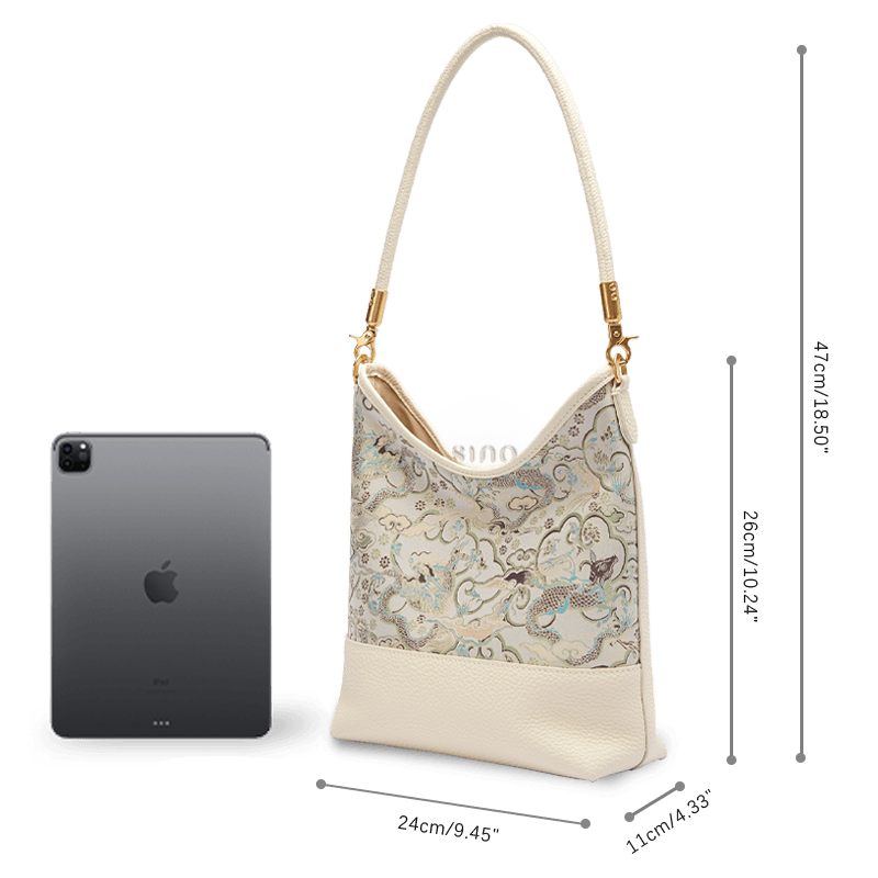 Size and capacity comparison of the Chinoiserie Luxury Song Brocade Ox-Head Dragon Leather Shoulder Bag shown beside a tablet.