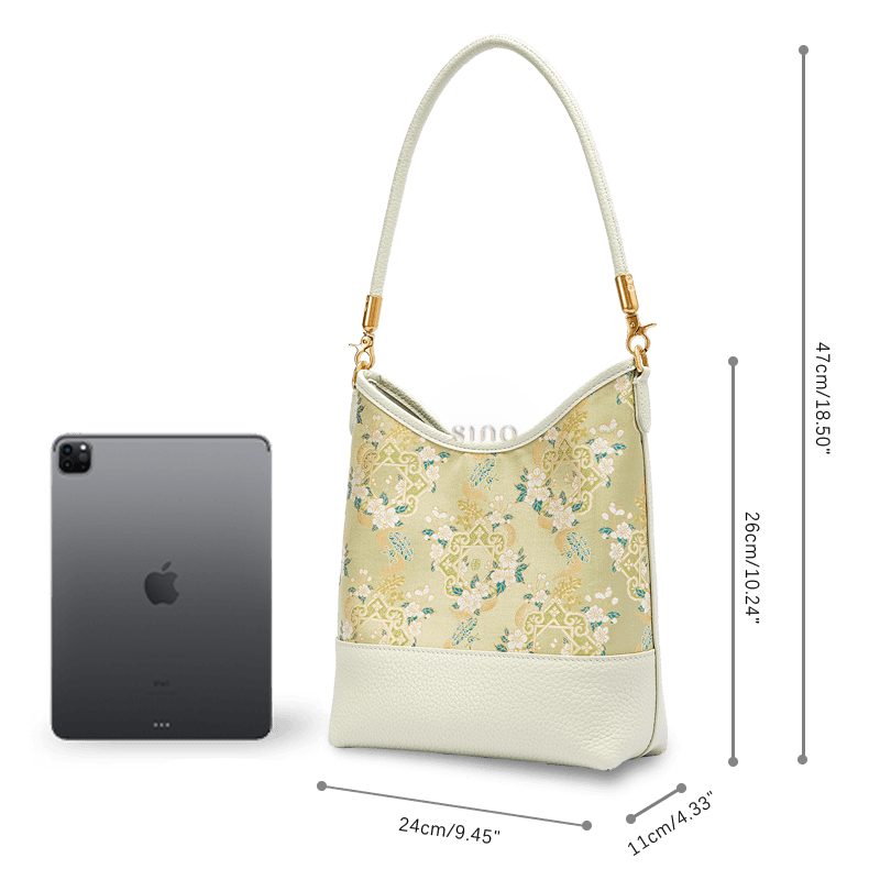 Size and capacity comparison of the Ruyi Blossom Song Brocade leather shoulder bag beside a tablet.