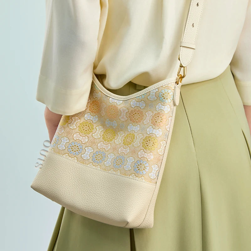 Back lifestyle view of the Chinoiserie Luxury Song Brocade Ruyi Victory Leather Shoulder Bag worn by a model with an adjustable shoulder strap.