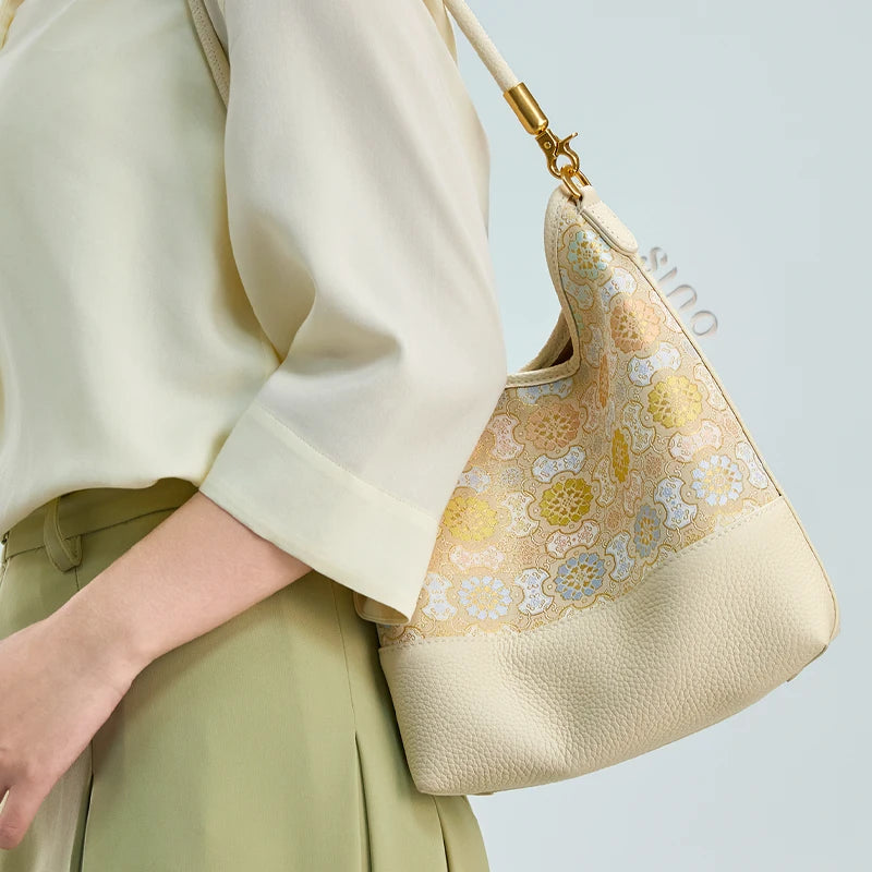 Side lifestyle view of the Chinoiserie Luxury Song Brocade Ruyi Victory Leather Shoulder Bag showing the soft silhouette and brocade pattern.