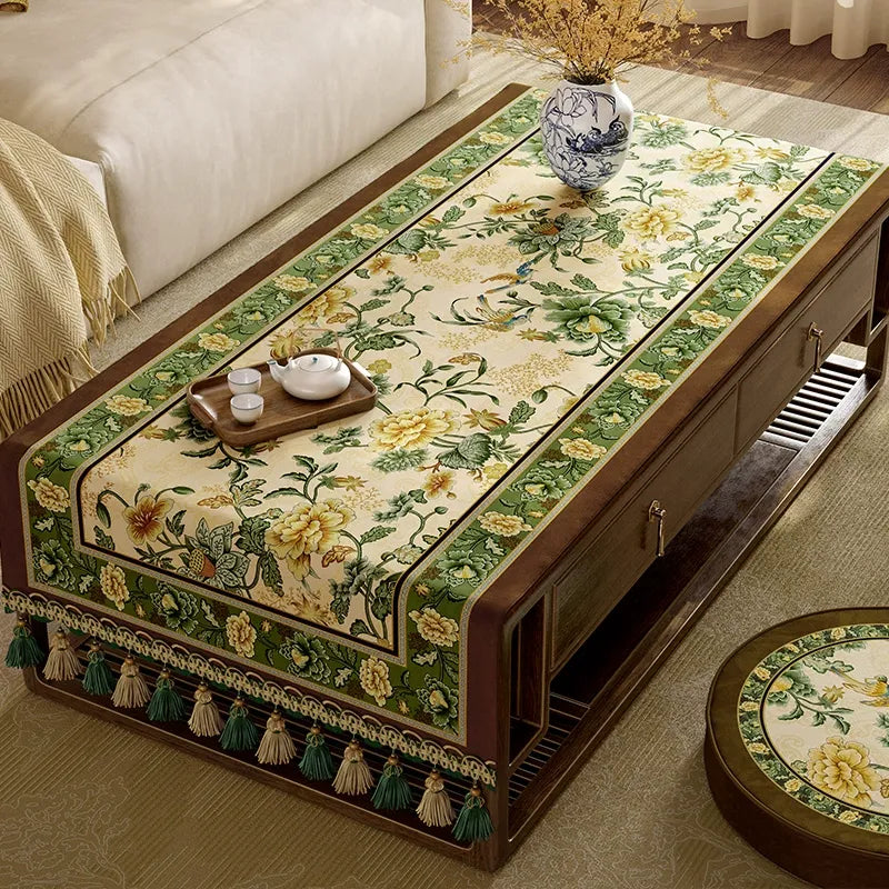Green vintage tablecloth fully covering
table.